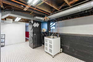 Basement with stacked washer and dryer