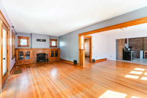 Unfurnished living room featuring light hardwood / wood-style floors and a fireplace