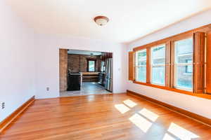 Unfurnished living room featuring wood-type flooring and a fireplace