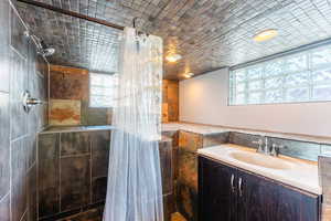 Bathroom featuring walk in shower and vanity