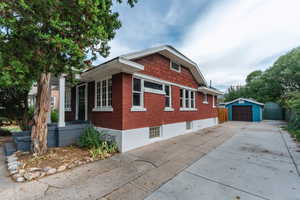 View of home's exterior with a garage and an outbuilding