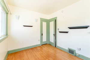 Unfurnished room featuring light hardwood / wood-style flooring and a wealth of natural light