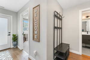 Hall with sink and light hardwood / wood-style floors