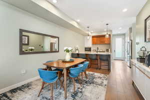 Dining room with light hardwood / wood-style flooring