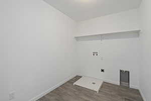 Laundry area featuring washer hookup, electric dryer hookup, and dark wood-type flooring