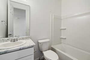 Full bathroom with  shower combination, vanity, and toilet