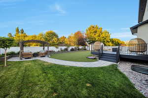 View of yard with a pergola and a deck