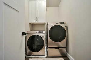 Laundry room featuring washer, dryer and cabinets