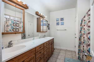 Bathroom featuring vanity and tile patterned flooring