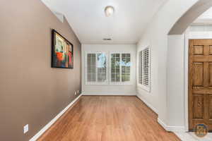 Wide entryway with light hardwood / wood-style floors .