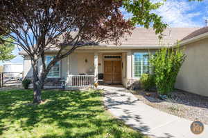 Property entrance with a lawn and a porch