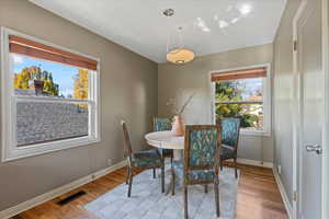 Dining space with light hardwood / wood-style flooring