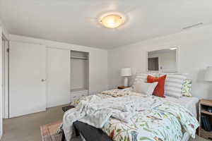 Bedroom with carpet floors and a closet