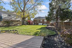 View of yard featuring a storage shed and a wooden deck