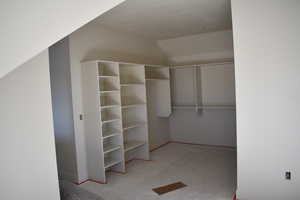 Walk in closet with vaulted ceiling