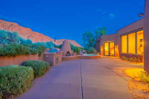 Patio at twilight with a mountain view and area for grilling