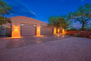 Pueblo-style house featuring a garage