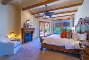 Carpeted bedroom with beamed ceiling, ceiling fan, and access to exterior