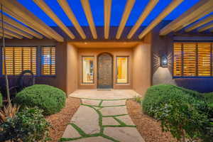 Entrance to property featuring a pergola