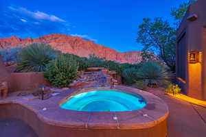 View of pool featuring a patio, an in ground hot tub, and a mountain view