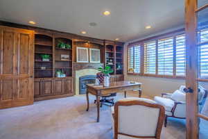 Office area featuring light carpet