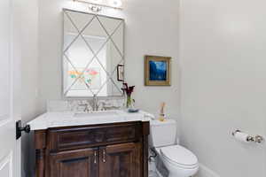 Bathroom featuring vanity and toilet