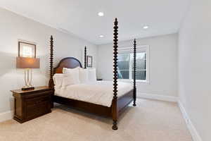 Bedroom featuring light colored carpet