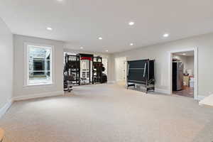 Exercise room with light colored carpet