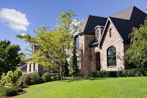 View of side of home featuring a yard