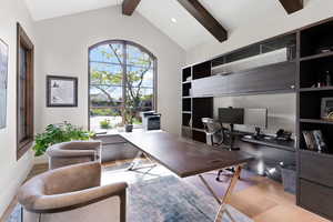 Home office with vaulted ceiling with beams and white oak floors