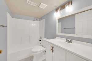 Full bathroom featuring tile patterned floors, vanity, bathtub / shower combination, and toilet