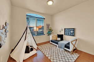 Sitting room with hardwood / wood-style floors