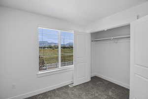 Upstairs bedroom #3 (photo is from a different community.  View outside the window will be of the common space behind the home.)