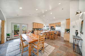 Dining room with french doors and high vaulted ceiling