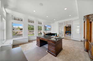 Carpeted office space featuring ornamental molding. Could be future second kitchen