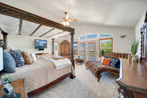 Primary Bedroom featuring vaulted ceiling, French door access to exterior deck, ceiling fan, and light carpet