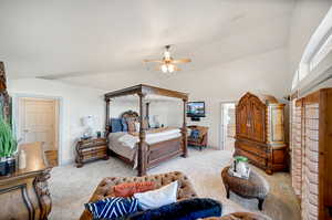 Carpeted Primary Bedroom featuring lofted ceiling and ceiling fan