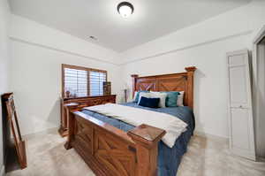 Carpeted bedroom featuring lofted ceiling