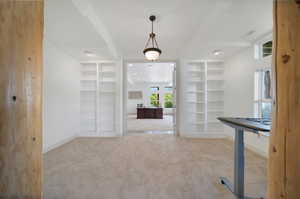 Entrance foyer featuring light colored carpet