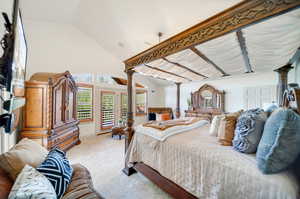 Primary Bedroom with light carpet, lofted ceiling, and mountain views