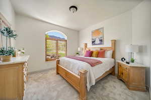 Bedroom featuring light colored carpet