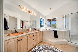 Primary Bathroom featuring double vanity, copper sinks, vaulted ceiling, and plus walk in shower