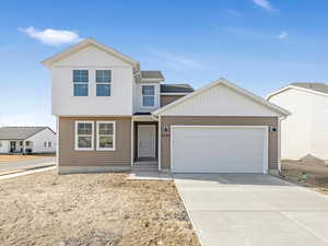 View of front of property with a garage and driveway