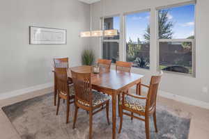 Tiled dining room featuring an inviting chandelier