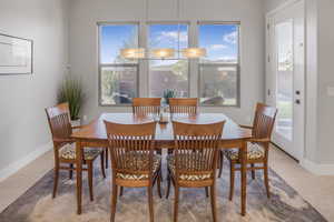 Tiled dining space featuring plenty of natural light