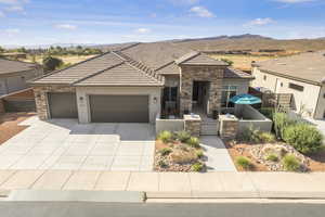 View of front of property featuring a mountain view and a garage