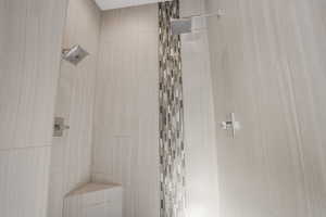 Bathroom featuring a tile shower