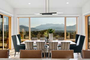 Dining area with light hardwood / wood-style flooring and a mountain view