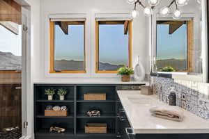 Bathroom featuring vanity, tasteful backsplash, and a wealth of natural light