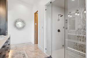 Bathroom featuring walk in shower and vanity